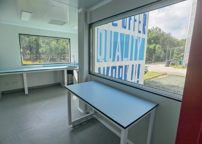 Pharmaceutical modular cleanroom with windowed process room and cleanable wall panels